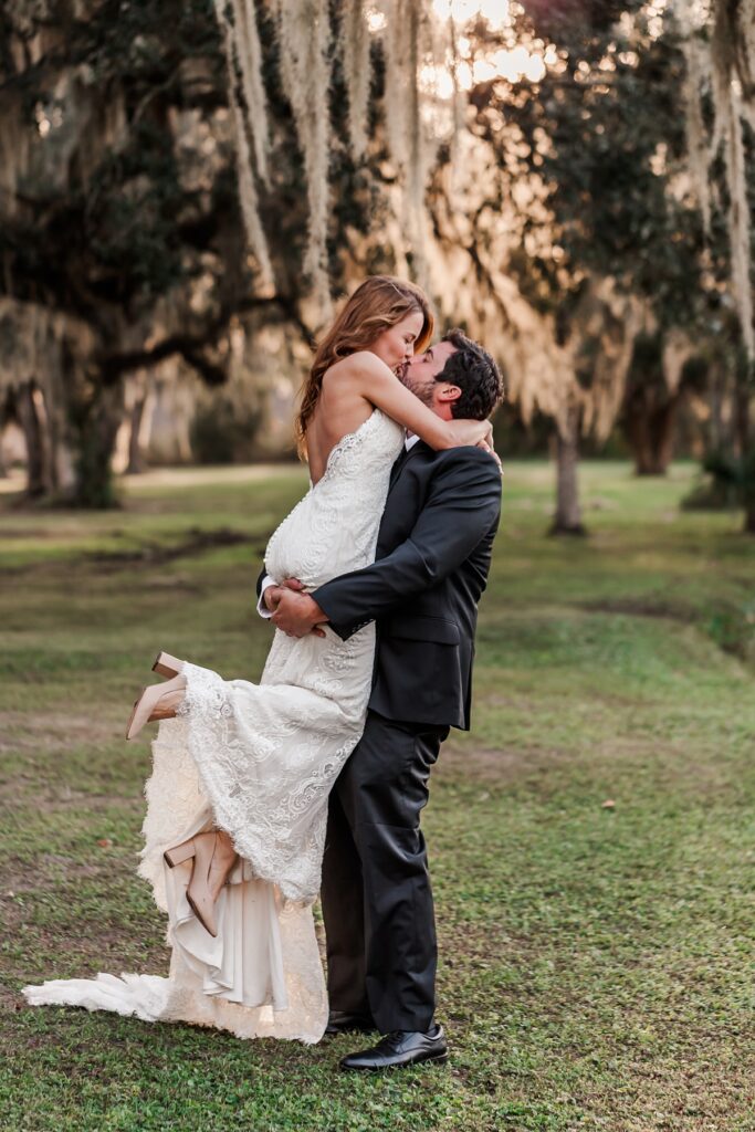 groom lifting and kissing bride