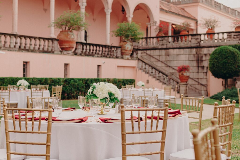 a classic tablescape from an outdoor wedding reception in the ringling museum of art's courtyard.