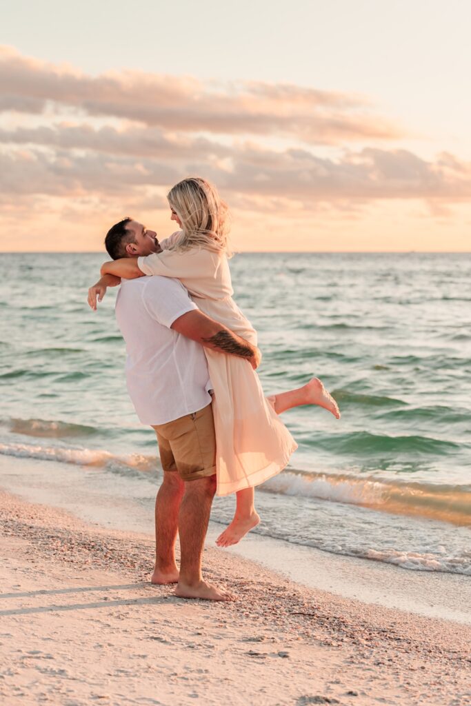 A sweet moment as the sun sets over Pass-a-Grille Beach during this engagement session.